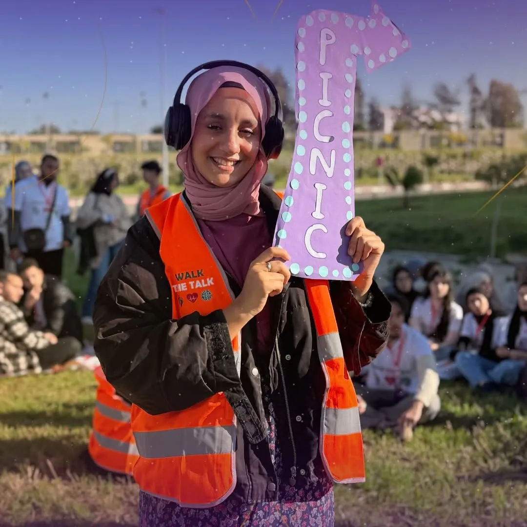 An EUNOIA organizer holding a picnic sign